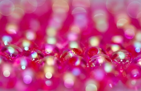 close up of red beads with shinning reflection abstractの写真素材