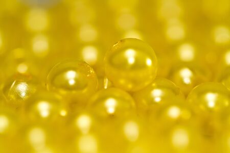 Yellow beads under sun lights in close upの写真素材