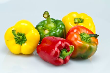 five capsicums on bluish surface の写真素材