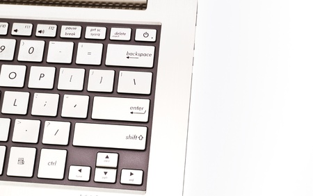 Angled view of a keyboardpad on a modern metal-finished laptop against white for abstract and backgroundの写真素材