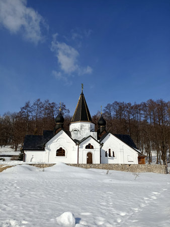 Russian orthodox church in winter snow weather with blue February sky