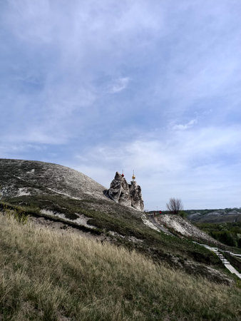 Holy orthodox churches and monastery in caves of the hills of chalk mountains in early spring season...