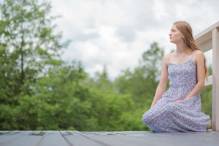 Teen woman relax sit outside parkの写真素材