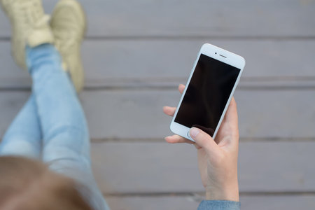 Hand of a woman using smartphone