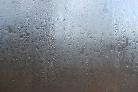 rain drops on a windowpane in cloudy weatherの写真素材
