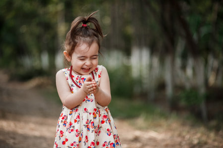 portrait of a little cute Caucasian girl in vintage clothes posing in the woods