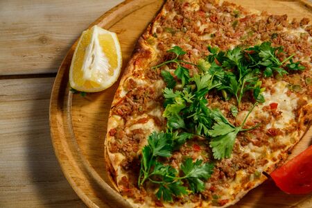 turkish food lahmacun on a wooden trayの写真素材