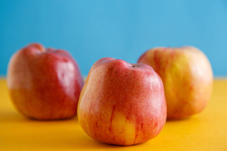 fresh apples on yellow-blue background