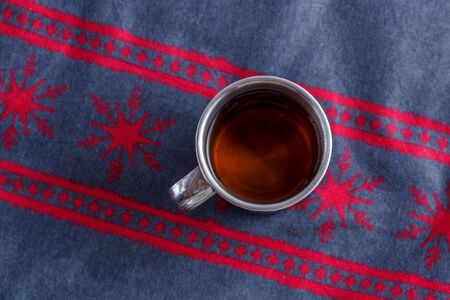 tea in a vintage mug on vintage Christmas backgroundの写真素材