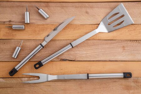 metal set for cutting meat and grilling on wooden backgroundの写真素材