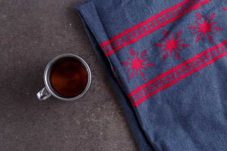 tea in a vintage mug on vintage Christmas background