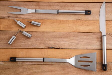 metal set for cutting meat and grilling on wooden backgroundの写真素材
