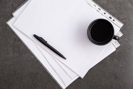paper sheet with copy space and black pen with cup coffeeの写真素材