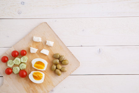 tea and Turkish,Mediterranean Breakfast of olives,eggs,cheese,tomatoes and cucumbers on a light...