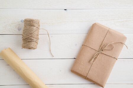 parcel,gift Packed in eco-friendly paper and twine for packing on light wooden background. the view from the topの写真素材