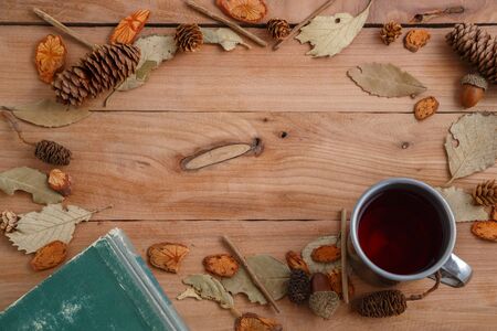 vintage book and drink in retro mug on wooden background. top view with space for textの写真素材