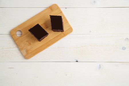 Brownie cake on a bamboo tray on a white wooden  with space for text. top viewの写真素材