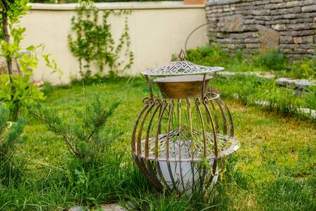 Vintage metal garden lantern on green lawnの写真素材