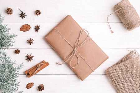 new year background. flatlay. cinnamon,spruce branches and Christmas gift on white wooden backgroundの写真素材