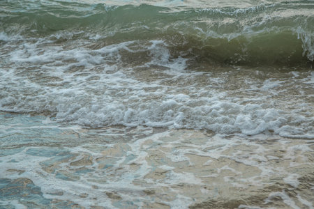 background of waves beating on a sandy beach in stormy weather