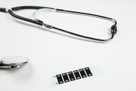 medical stethoscope, medication and thermometer-strip on white isolated background