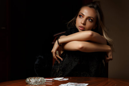 young Caucasian  woman undressing after losing at cardsの写真素材