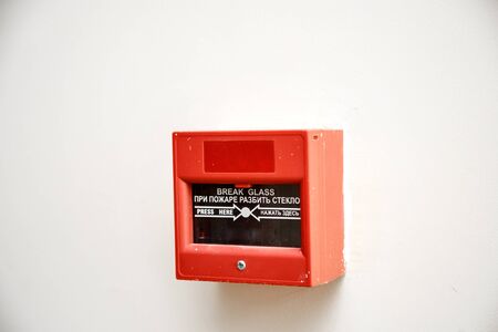 fire alarm button . with inscription in English and translation into Russianの写真素材