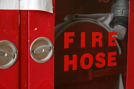 fire extinguisher box with the words "fire hose" . selective focus. shallow depth of focusの写真素材