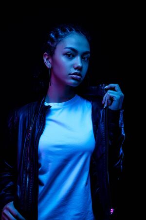 Close up portrait of Fashion young american African girl woman camera isolated on a blackの写真素材