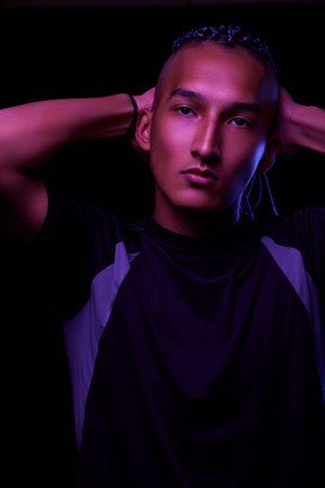 portrait of a young naked african man at studio. High Fashion male model in colorful neon bright...