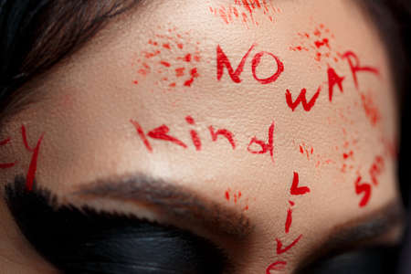 face of a young Asian girl close up with the inscription no war.の写真素材