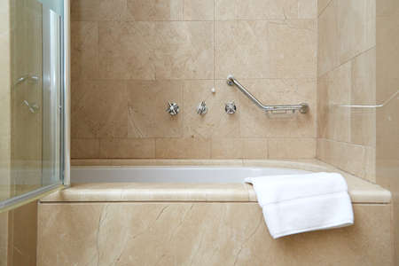 white clean foot towel on the edge of the bathroom. in the bathroom interior.の写真素材