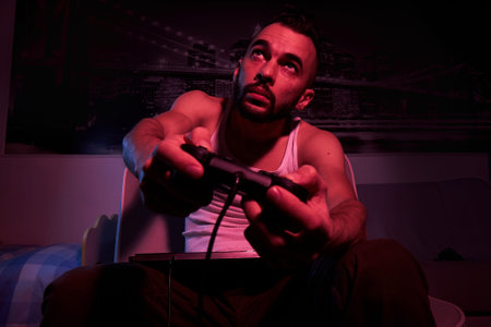 a thirty-year-old guy with a joystick in his hands is playing computer games, experiencing various...