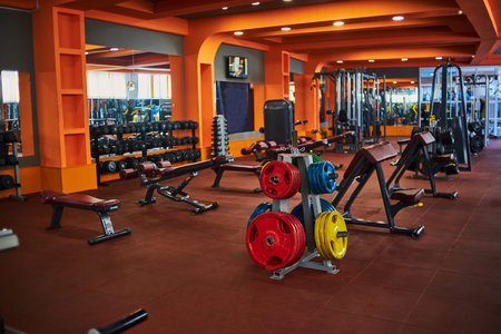 various exercise machines in the gym. selective focus, low depth of focus. a small grain for...