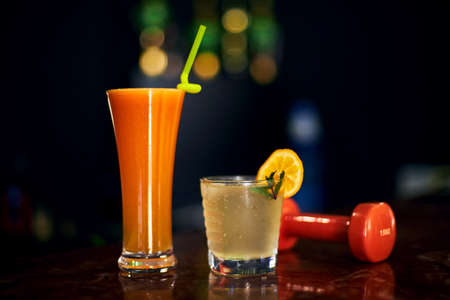 freshly squeezed juice and an invigorating cocktail in the gym. selective focus, low depth of focus. a small grain for artistic effect.の写真素材
