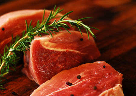 Raw, red, fresh meat pork on a cutting board.の写真素材