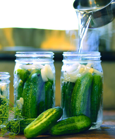 Canned cucumbers process at home container and lid and spices.の写真素材