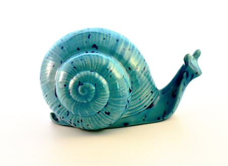 Ceramic figurine snails blue color on a white background.の写真素材