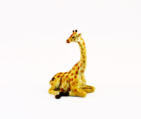 Ceramic figurine of a giraffe on a white background.の写真素材