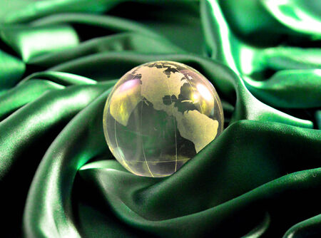 Glass paperweight crystal clear color on a green  background.の写真素材
