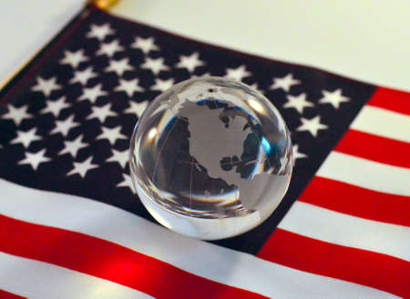 Glass ball globe on American flag background.の写真素材