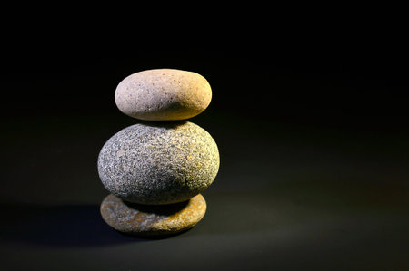 Small zen stone tower on a black background.の写真素材