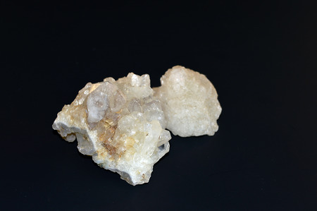 A large piece of white quartz crystal on a black background.の写真素材