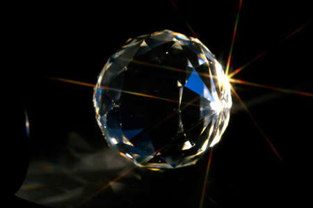 Crystal ball on black background with rays.の写真素材