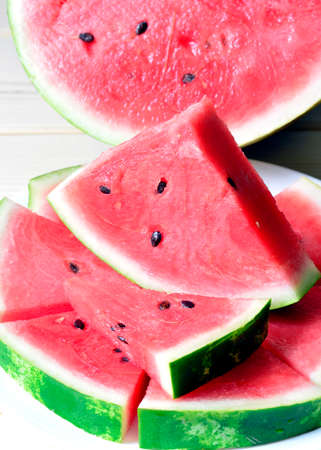 Ripe juicy red watermelon sliced ââpieces on the table.の写真素材