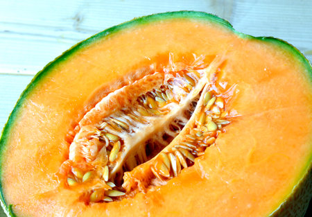 Cantaloupe melon slices of fresh juicy yellow red green.