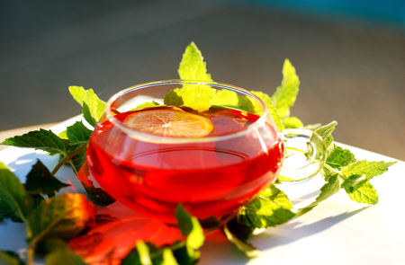 Fresh tea flavored with lemon in a beautiful beautiful cup.の写真素材