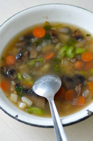 Portobello mushroom soup in a white enamel bowlの写真素材