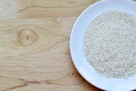 White raw rice in a bowl on a cutting boardの写真素材