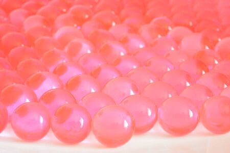 Hydrogel peach balls wet  shiny round  backgroundの写真素材